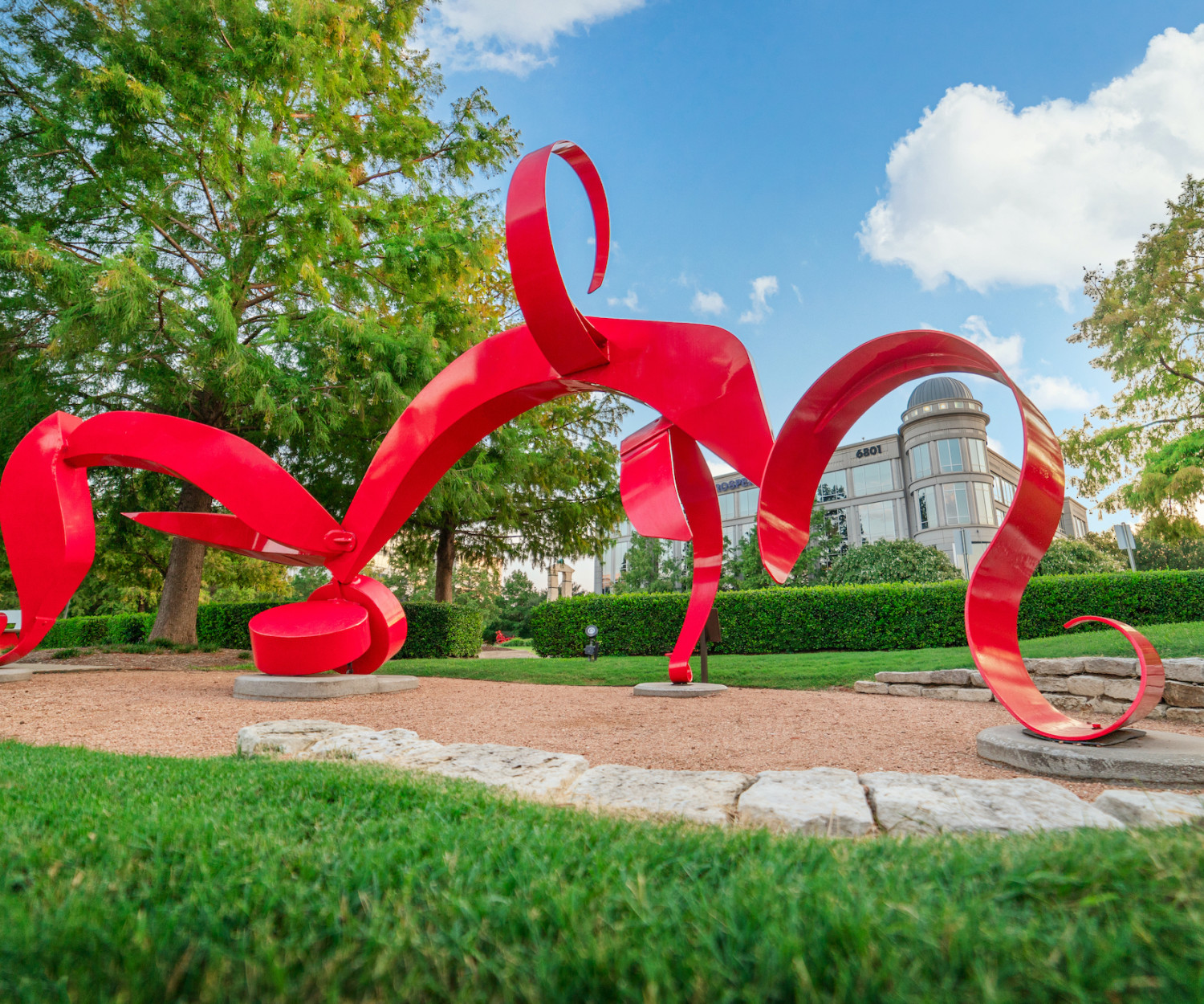 A red and windy statue at the Texas Sculpture Garden