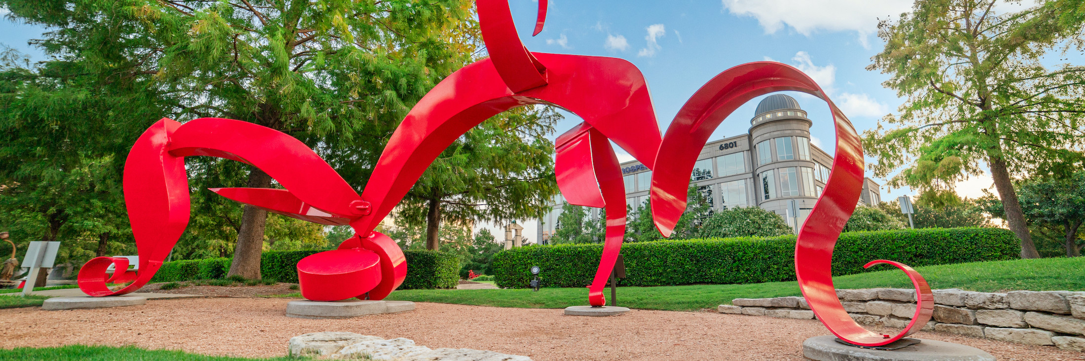 A red and windy statue at the Texas Sculpture Garden