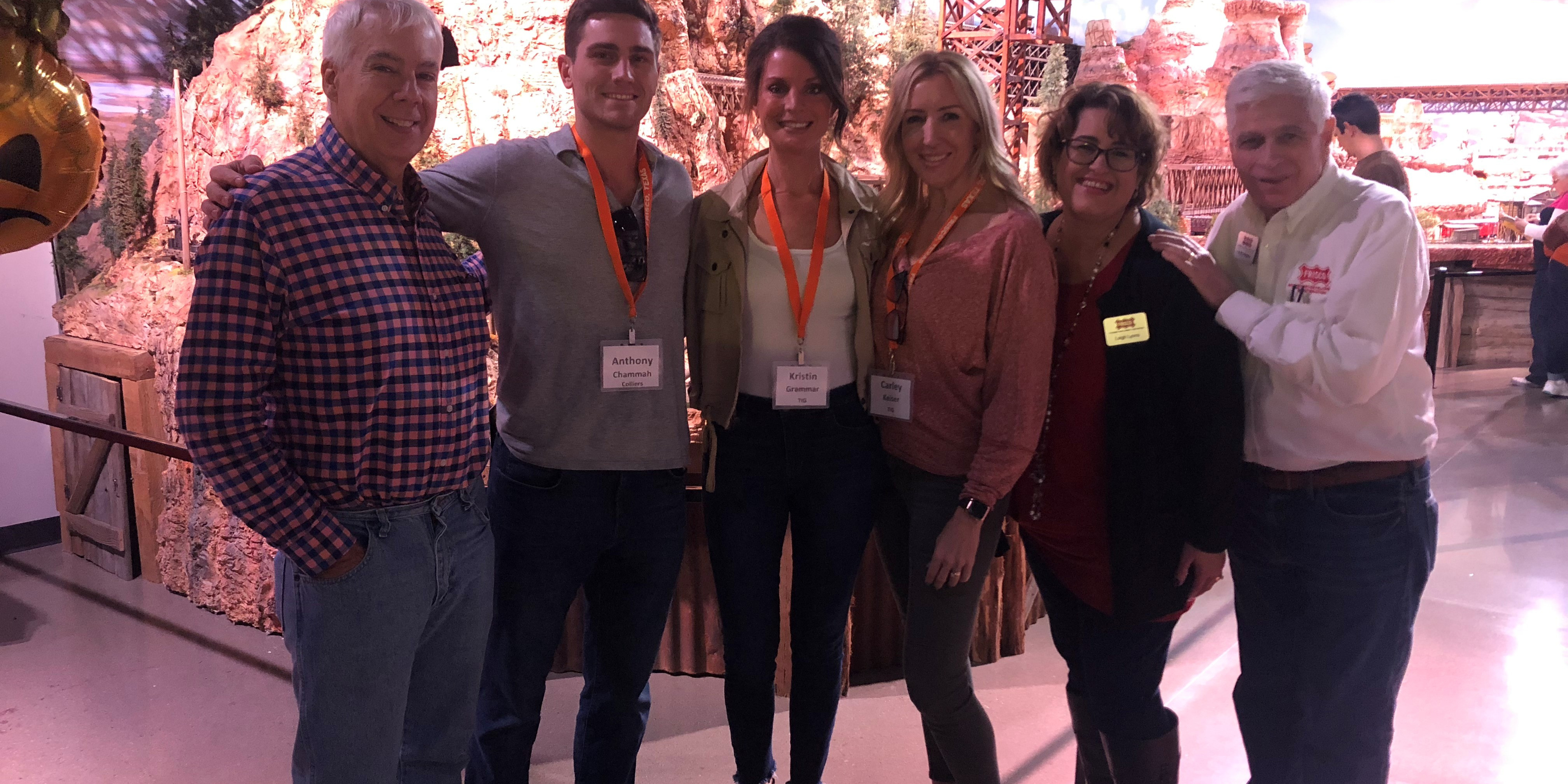 Six people gather for a photo at Train Topia.