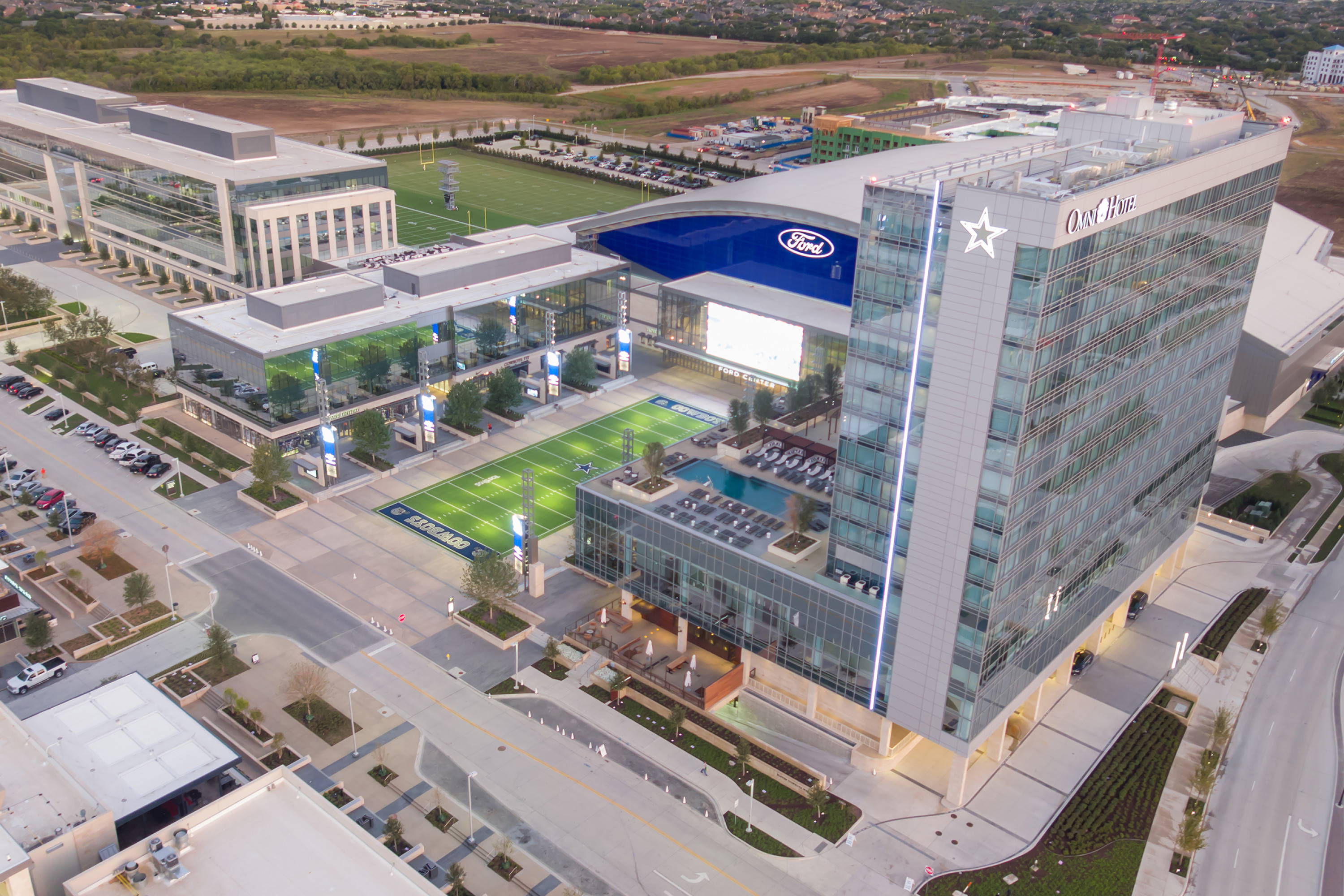 Aerial shot of the Omni Frisco Hotel, Ford Center at The Star, and Tostito's Plaza.