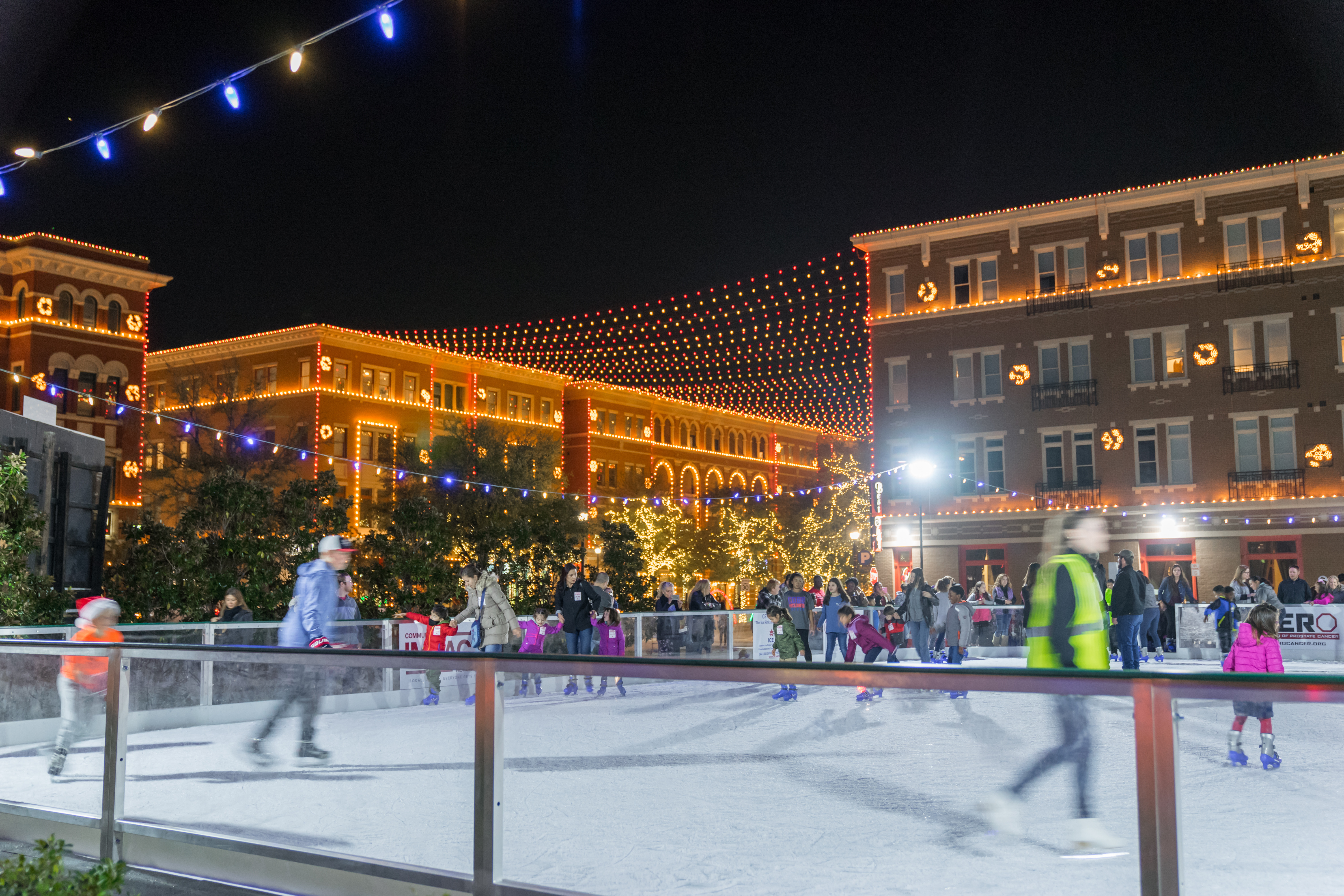 People participate in Christmas In The Square by skating on the skate rink.
