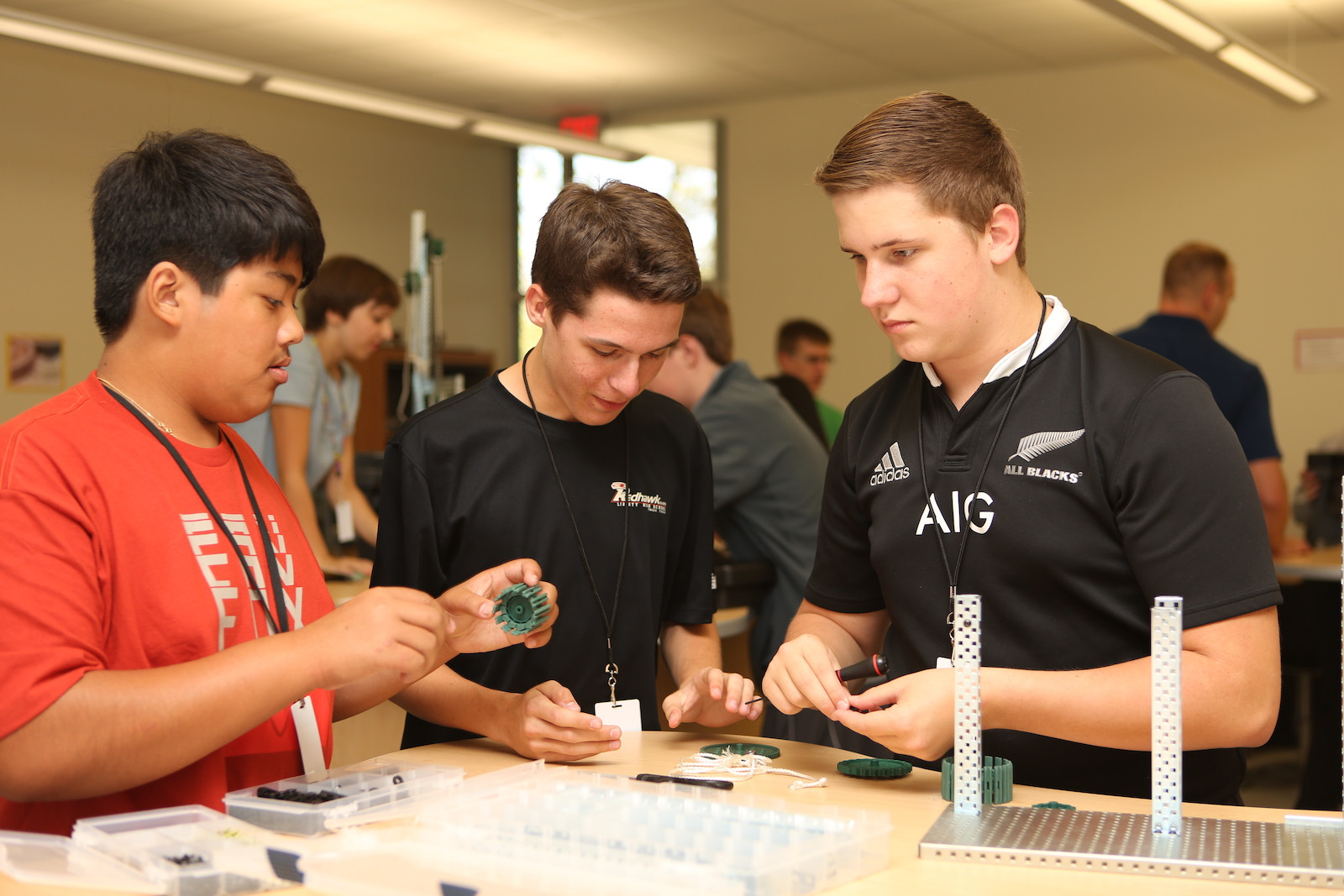 Three students work together on a project in class.