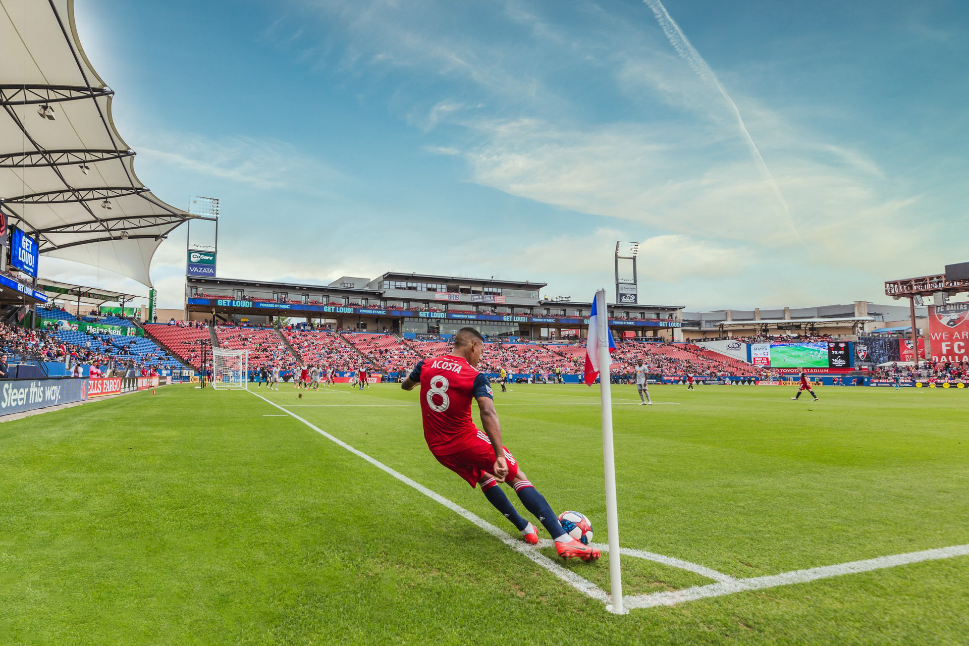 A soccer player performs a corner kick at Toyota Stadium.