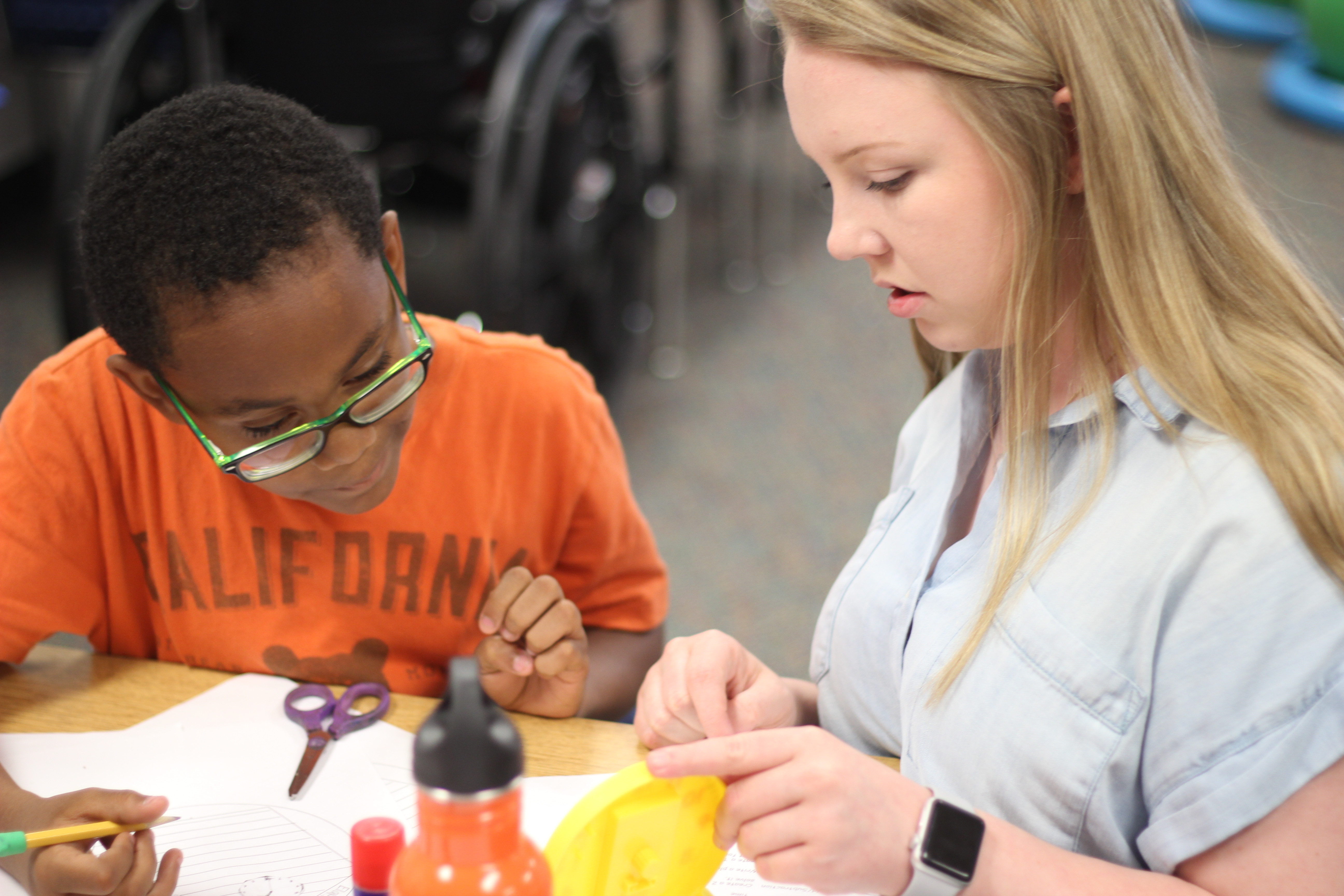 Two students work together in class on a project.