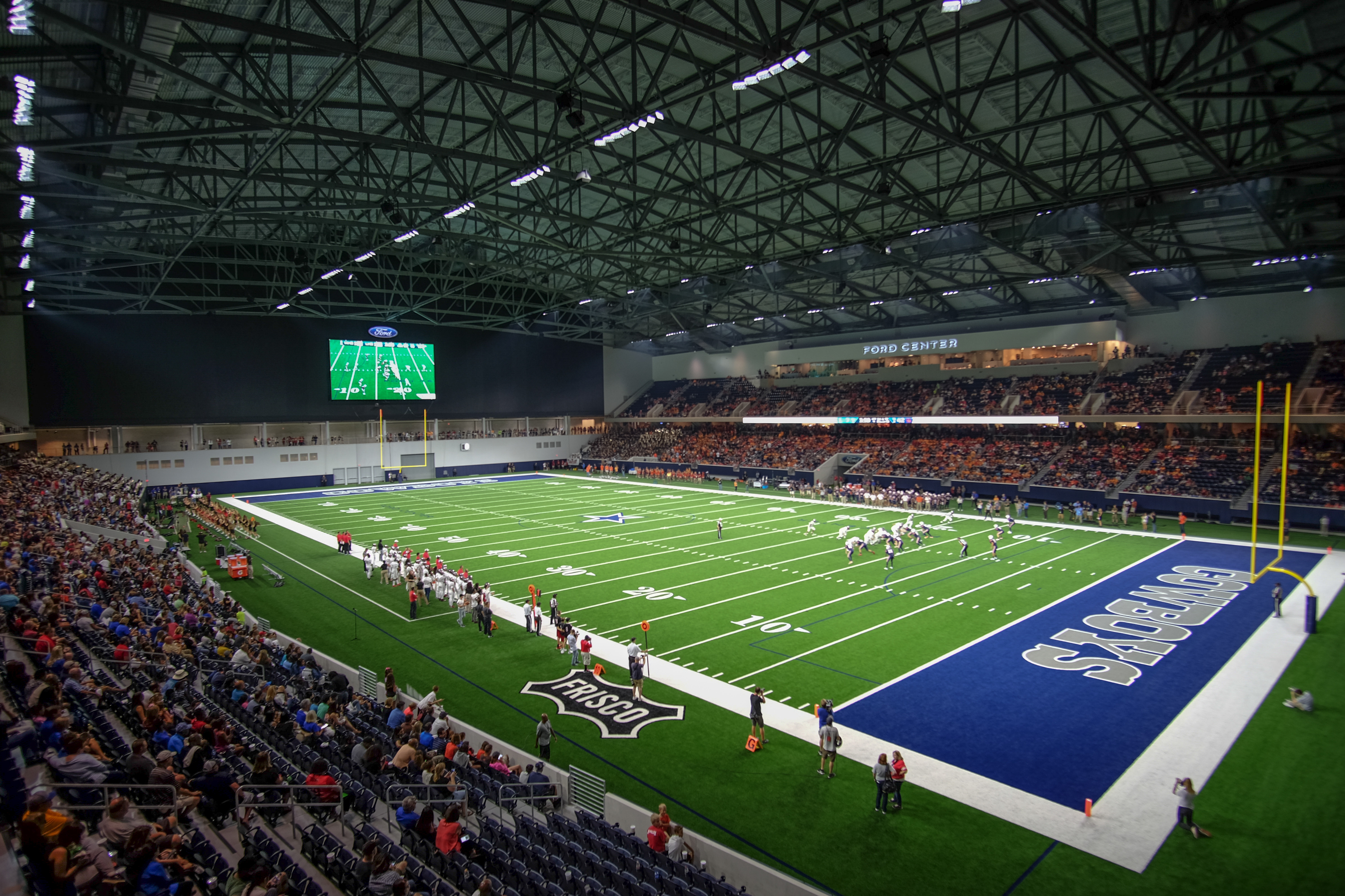 A wise shot of a high school football game happening inside Ford Center at The Star.