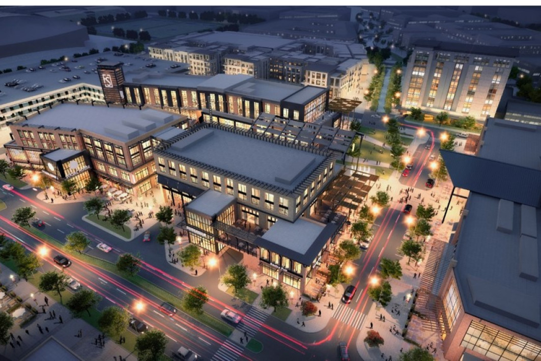 Aerial rendering of Frisco Station. There are shops, apartment buildings, and a parking garage.