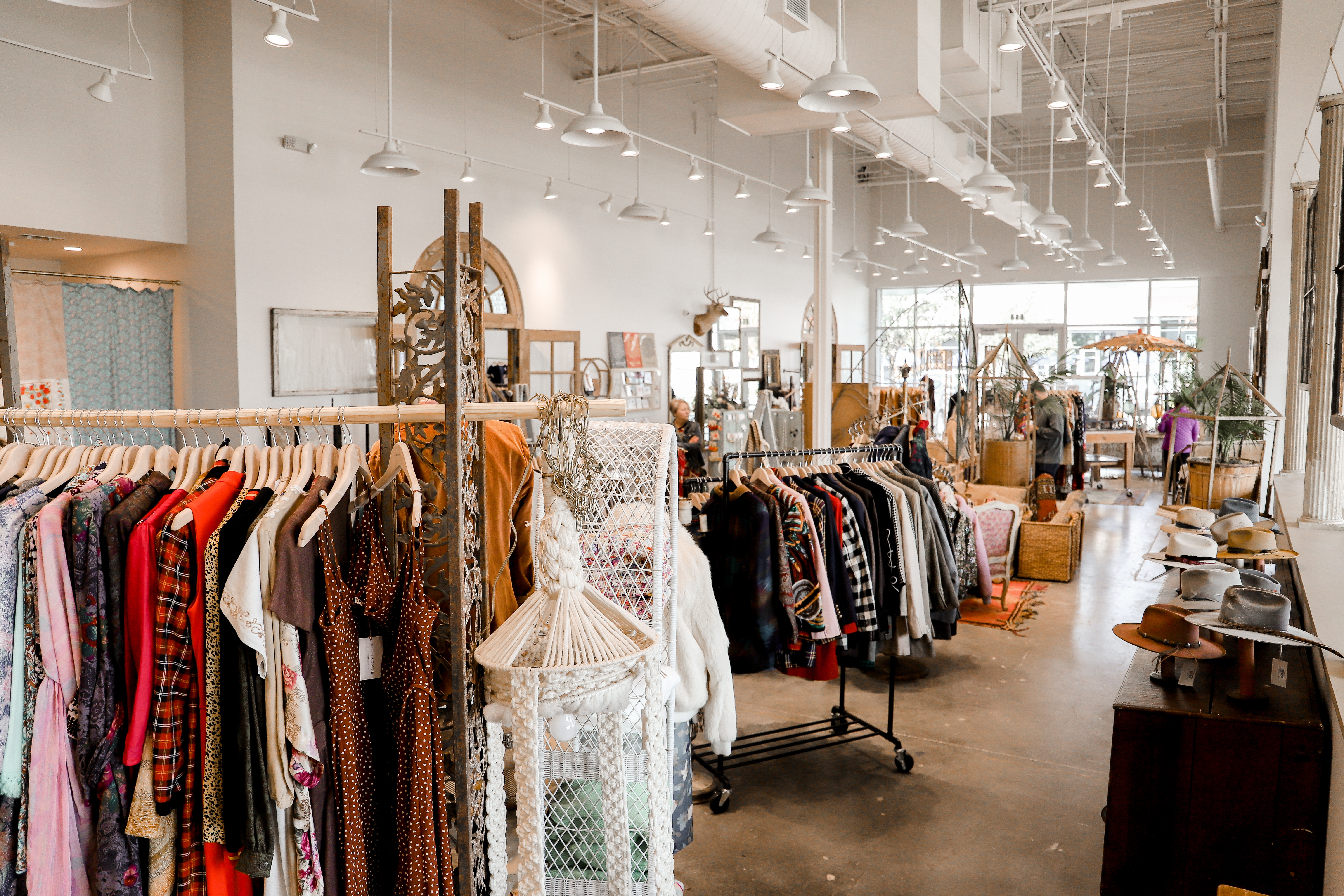 Racks of clothes and handmade hats inside Flea Style.