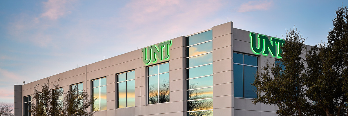 A 2-story building with the University of North Texas green UNT logo.