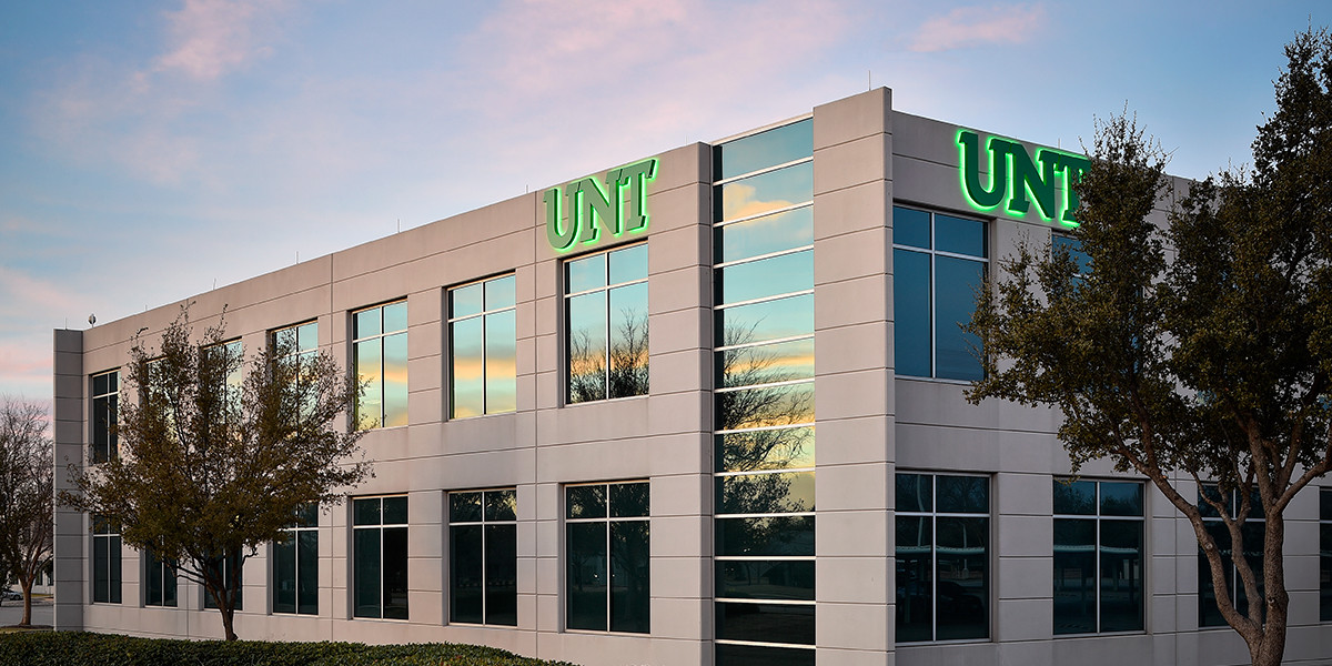A 2-story building with the University of North Texas green UNT logo.